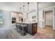 Modern kitchen with white cabinets, stainless steel appliances, a large island, and pendant lighting at 522 Fern Hill Rd # 17, Mooresville, NC 28117