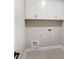 Clean, simple laundry room with white cabinets and connections for a washer and dryer at 522 Fern Hill Rd # 17, Mooresville, NC 28117