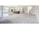Open-concept living room and kitchen with hardwood floors and large windows, offering bright, modern space at 522 Fern Hill Rd # 17, Mooresville, NC 28117