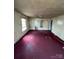 A large living room needing renovation, featuring a window and open access to other rooms, with visible wear at 529 Devine St, Chester, SC 29706