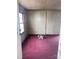 Unfurnished room with a window, a door, and outdated interior finishes needing renovation and updating at 529 Devine St, Chester, SC 29706