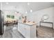 Bright, modern kitchen featuring an island with seating, stainless appliances, and an open living space at 5824 Patton St, Charlotte, NC 28269