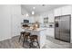 Modern kitchen with white cabinets, granite countertops, stainless steel appliances, and a stylish island with seating at 5824 Patton St, Charlotte, NC 28269