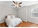 Cozy bedroom featuring a queen-size bed, hardwood floors, and natural light at 5980 Pale Moss Ln, Charlotte, NC 28269