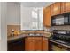 Well-equipped kitchen featuring wooden cabinets, granite countertops, and modern appliances for a functional cooking space at 5980 Pale Moss Ln, Charlotte, NC 28269