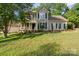 Traditional-style home with a welcoming front porch, dark shutters and a well-maintained front lawn at 6210 Skyline Dr, Charlotte, NC 28269
