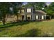 Traditional-style home with a welcoming front porch, dark shutters and a well-maintained front lawn at 6210 Skyline Dr, Charlotte, NC 28269