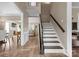Inviting foyer features hardwood floors, staircase with wooden banister, and open view to living spaces at 6210 Skyline Dr, Charlotte, NC 28269