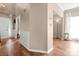 Bright foyer with hardwood floors, white wainscoting, and views into the entryway and front door at 6210 Skyline Dr, Charlotte, NC 28269