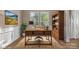 Bright home office with a wooden desk, chair, bookshelf, decorative rug and ample natural light at 6210 Skyline Dr, Charlotte, NC 28269