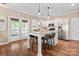 Well-lit kitchen featuring a large island, stainless steel appliances, and hardwood floors at 6210 Skyline Dr, Charlotte, NC 28269