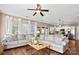 Bright living room with large windows, hardwood floors, and a comfortable sectional sofa at 6210 Skyline Dr, Charlotte, NC 28269