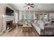 Cozy living room with a brick fireplace, large windows, and a comfortable sectional sofa at 6210 Skyline Dr, Charlotte, NC 28269