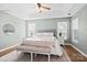 Bright main bedroom featuring a tray ceiling, neutral colors, and a bench at 6210 Skyline Dr, Charlotte, NC 28269