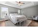 Cozy main bedroom featuring a tray ceiling, neutral colors, and a sitting area at 6210 Skyline Dr, Charlotte, NC 28269