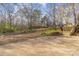 Expansive backyard featuring a patio and steps leading to a wooded area, perfect for outdoor living and relaxation at 624 Flicker St, Concord, NC 28027
