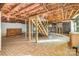 Unfinished basement area with stairs, storage shelves, and exposed ceiling insulation at 624 Flicker St, Concord, NC 28027