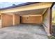 Covered carport with brick walls, concrete floor, and natural light from window at 624 Flicker St, Concord, NC 28027