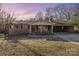 Charming brick home with covered front porch and carport; offering a blend of classic design and convenient parking at 624 Flicker St, Concord, NC 28027