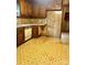 This kitchen features wood cabinets, a vintage dishwasher, and a unique geometric linoleum floor design at 624 Flicker St, Concord, NC 28027