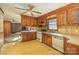 Retro kitchen with wood cabinets, vintage appliances, patterned flooring, and view of connected living space at 624 Flicker St, Concord, NC 28027
