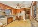 Functional kitchen featuring wood cabinetry, a vintage stovetop, a window, and a view into another room at 624 Flicker St, Concord, NC 28027
