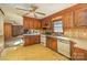 Retro kitchen with wood cabinets, vintage appliances, patterned flooring, and view of connected living space at 624 Flicker St, Concord, NC 28027