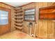 Utility room with wood paneling, shelving, a window, and connections for laundry appliances at 624 Flicker St, Concord, NC 28027