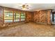 Inviting living room with wood walls, large windows offering natural light and views of the outdoors at 624 Flicker St, Concord, NC 28027