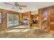 Open floor plan with a view of the dining area with deck access and the kitchen with wooden cabinetry at 624 Flicker St, Concord, NC 28027