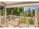 Back porch with white railing overlooking a natural area with mature trees at 719 N Fulton St, Salisbury, NC 28144