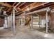 Unfinished basement with exposed brick walls, duct work, and concrete flooring at 719 N Fulton St, Salisbury, NC 28144