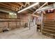 Spacious unfinished basement with exposed brick walls, wooden beams, and concrete floors at 719 N Fulton St, Salisbury, NC 28144