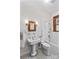 Traditional bathroom with mosaic tile floor, pedestal sink, and white tiled bath/shower at 719 N Fulton St, Salisbury, NC 28144