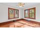 Bedroom featuring hardwood floors, wooden trim windows, and a ceiling fan at 719 N Fulton St, Salisbury, NC 28144