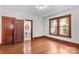 Bedroom with hardwood floors, wooden trim windows and a doorway that leads to a bathroom at 719 N Fulton St, Salisbury, NC 28144