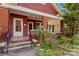 Charming brick front porch with columns, a tile floor, and wrought iron railings at 719 N Fulton St, Salisbury, NC 28144