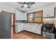Kitchen with white cabinetry, marble countertops, hardwood floors and stainless appliances at 719 N Fulton St, Salisbury, NC 28144