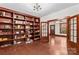 Cozy living room features a large built-in bookshelf, a ceiling fan and wood flooring at 719 N Fulton St, Salisbury, NC 28144