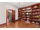 A second view of a living room featuring a large bookcase and hardwood flooring at 719 N Fulton St, Salisbury, NC 28144
