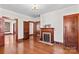 View of the living room showcasing hardwood floors, fireplace and multiple entryways at 719 N Fulton St, Salisbury, NC 28144