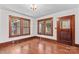 Living room with hardwood floors and large windows with detailed wood trim at 719 N Fulton St, Salisbury, NC 28144