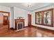Living room with hardwood floors, fireplace with mantel and large windows with wooden trim at 719 N Fulton St, Salisbury, NC 28144