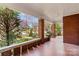 Long brick porch with mosaic tile floor, brick pillars and view of the front yard and neighborhood at 719 N Fulton St, Salisbury, NC 28144