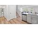Open kitchen with stainless steel dishwasher and view to living room at 722 Herlong Ave, Rock Hill, SC 29732