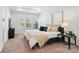 Bright main bedroom with lots of natural light, and neutral colored walls and carpet at 722 Herlong Ave, Rock Hill, SC 29732