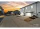 New construction townhomes featuring driveways and white siding along a quiet street at sunset at 722 Herlong Ave, Rock Hill, SC 29732