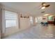 Spacious living area with large windows, ceiling fan, and wood-look flooring throughout at 746 Elders Story Rd, Fort Mill, SC 29708