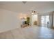 Open-concept living room with light wood floors, stylish sconces, and sliding glass doors to outdoor space at 746 Elders Story Rd, Fort Mill, SC 29708