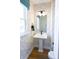 Modern bathroom featuring stylish wallpaper, pedestal sink, and contemporary lighting at 8026 Cedarsmith Ct, Charlotte, NC 28217